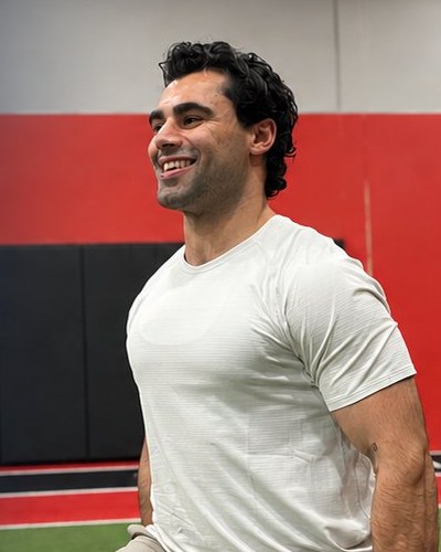 Coach Ali smiling in the gym